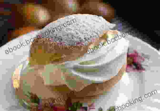 A Photo Of A Vibrant Semla Bun With A Swirl Of Whipped Cream And A Dusting Of Powdered Sugar. Guide To Cooking Nordic Bakery Delicious: With More 77 Recipes For Authentic Nordic Desserts