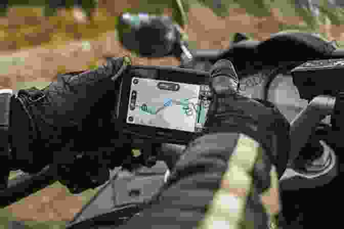 Person Using A GPS Device For Navigation On A Motorcycle. The Fundamentals Of Motorcycle Camping
